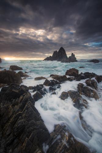Sunrise over Camel Rock near Bermagui on the NSW south coast - Australian Stock Image