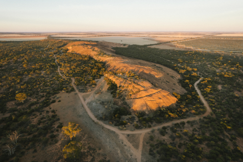Sunrise over Elachbutting Rock in the eastern Wheatbelt of Western Australia - Australian Stock Image