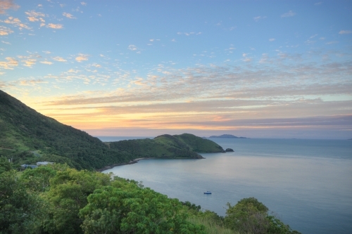 Sunrise over Keswick Island, part of the Whitsundays and Great Barrier Reef Islands - Australian Stock Image