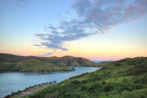 Sunrise over Keswick Island, part of the Whitsundays looking southwards to St Bees Island - Australian Stock Image