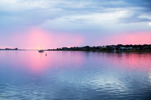 sunrise over river with moored boats - Australian Stock Image