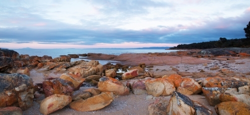 sunrise over rocky beach - Australian Stock Image