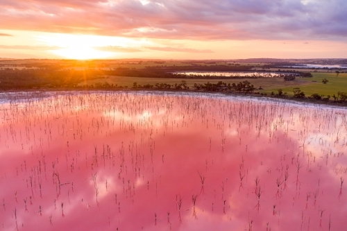 Sunset and a pink salt lake in Western Australia. - Australian Stock Image