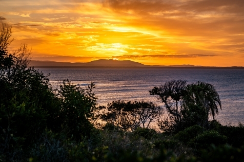 Sunset coastal landscape across Bustard Bay - Australian Stock Image