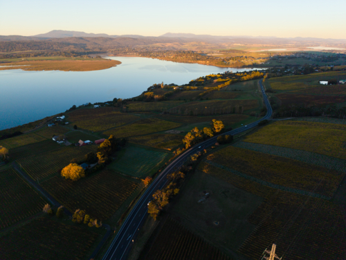 Sunset colours over the River Tamar with the curving West Tamar Highway below - Australian Stock Image