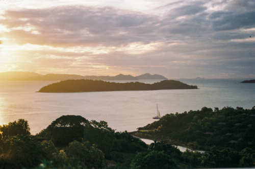 Sunset in Queensland with islands and sail boats in the distance - Australian Stock Image