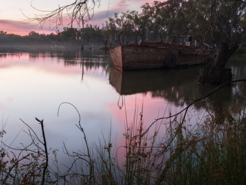 Sunset over a shipwreck at Kings Billabong - Australian Stock Image