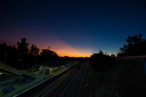 Sunset over a train station