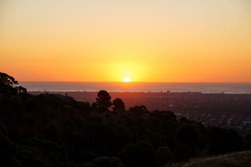 Sunset Over the City of Adelaide and the Ocean from a Hilltop Viewpoint - Australian Stock Image