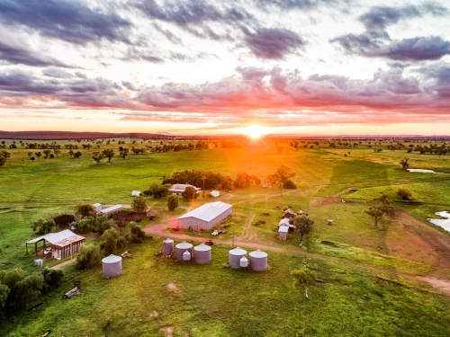 Sunset over tranquil family farm green grass after rain - Australian Stock Image