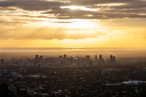 Sunset Silhouettes of city skyline on Hill Overlooking Adelaide from Mount Osmond, South Australia - Australian Stock Image