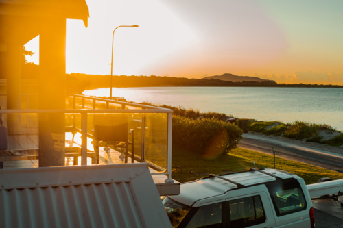 Sunset view of the beach and horizon from a balcony - Australian Stock Image