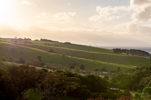 Sunshine Over Green Rolling Hillside - Australian Stock Image