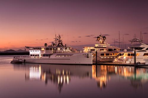 Superyachts at Coral Sea Marina during twilight.