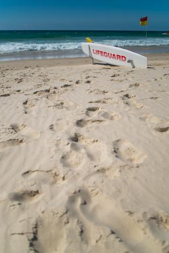 Surf Lifeguard on beach - Australian Stock Image