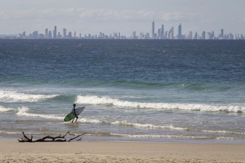 Surfer at Rainbow Bay - Australian Stock Image