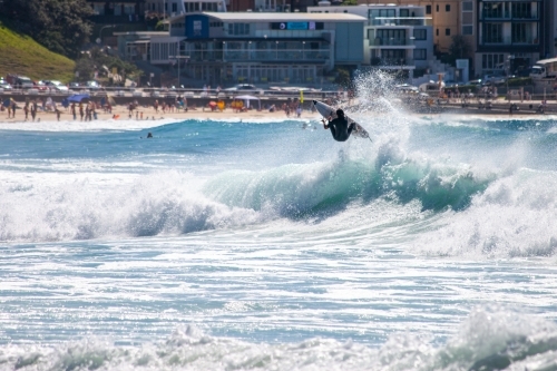 Surfer mid-air on a wave - Australian Stock Image
