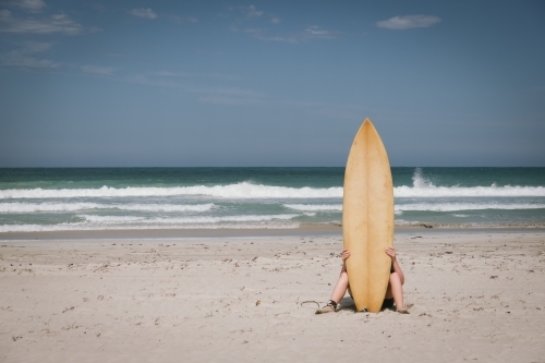 Surfer on the beach along the coast of Western Australia - Australian Stock Image