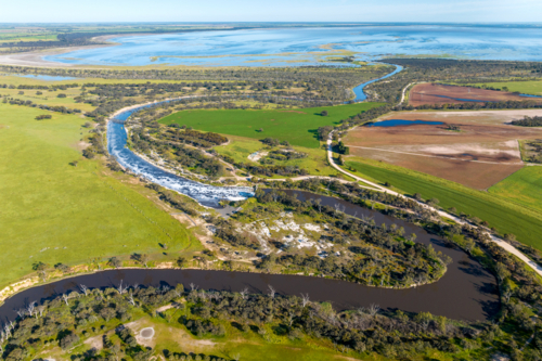 Sweeping aerial view of winding rivers, wetlands, and patchwork farmland - Australian Stock Image