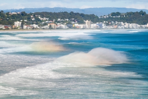 Swell on the water showing rainbow reflections along the Gold Coast - Australian Stock Image