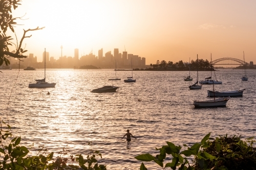 Swimmer enjoys the sunset over Sydney city