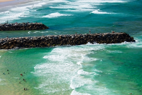 Swimmers and people spending time around the surf beach and mouth of the Evans River of Evans Head. - Australian Stock Image