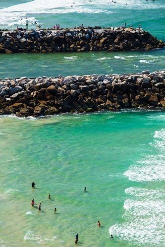 Swimmers and people spending time around the surf beach and mouth of the Evans River of Evans Head. - Australian Stock Image