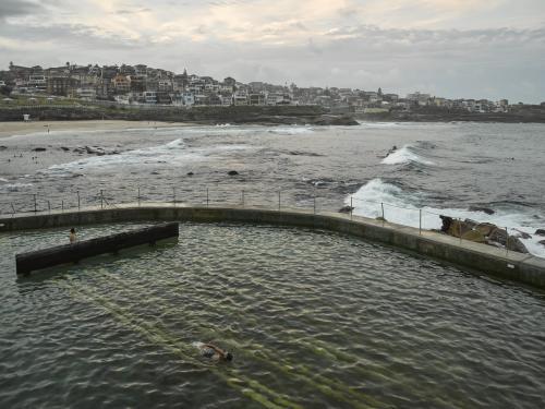 Swimmers at Bronte Ocean Pool on an overcast day