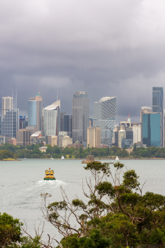 Sydney CBD with Storm Clouds as seen from Mosman with ferry in harbour - Australian Stock Image