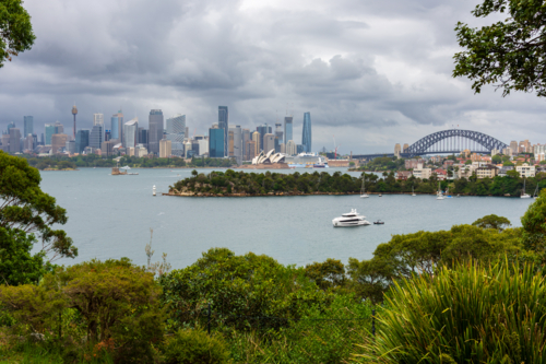 Sydney City, Opera House and Harbour Bridge on a cloudy day as seen from Mosman - Australian Stock Image