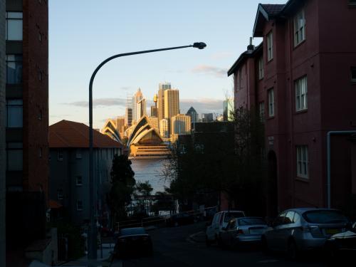 Sydney Opera House viewed between buildings on the north side of Sydney Harbour - Australian Stock Image