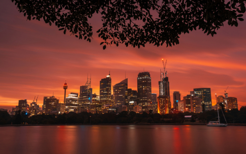 Sydney skyline at sunset across water - Australian Stock Image