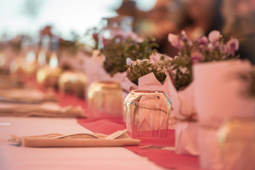 Table setting with flowers, and people in the background - Australian Stock Image
