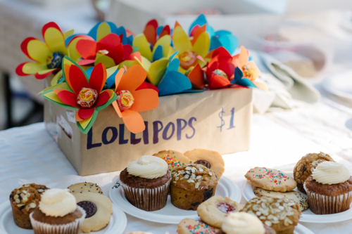 Table with setup shop selling baked goods and lollipops - Australian Stock Image