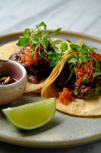 Tacos al pastor with lime - Australian Stock Image