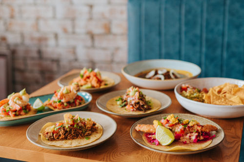 Tacos and Mexican Cuisine Displayed on Wooden Table at Restaurant - Australian Stock Image