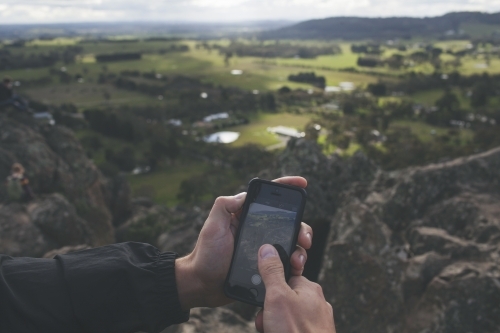Taking photos of a valley with a smartphone - Australian Stock Image