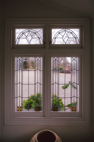 Tall narrow geometric stained-glass window - Australian Stock Image