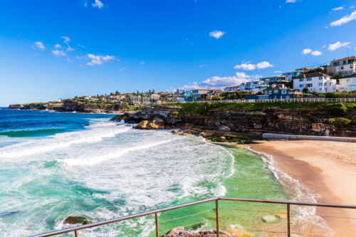 Tamarama Beach with houses along shoreline on a bright day, Sydney, Australia - Australian Stock Image