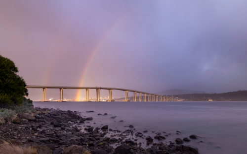 Tasman bridge at sunrise with rainbow behind - Australian Stock Image
