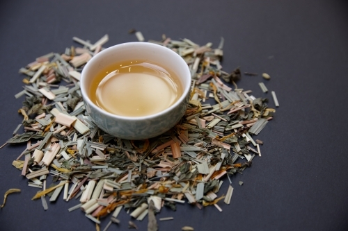 Tea leaves and drink on table - Australian Stock Image