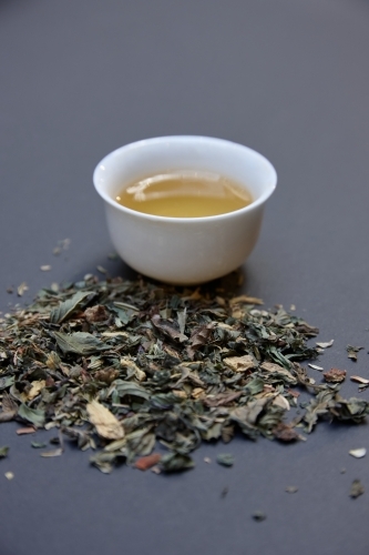 Tea leaves and drink on table - Australian Stock Image