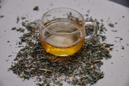 Tea leaves and drink on table - Australian Stock Image