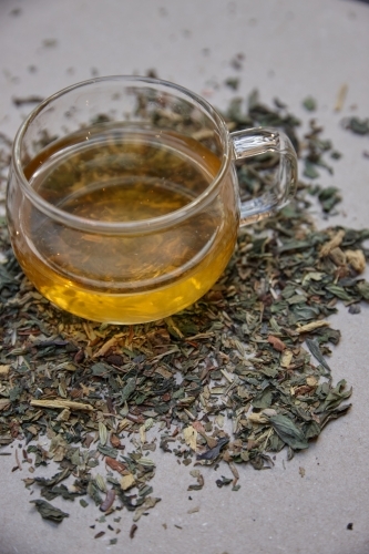 Tea leaves and drink on table - Australian Stock Image