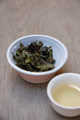 Tea leaves and drink on table - Australian Stock Image