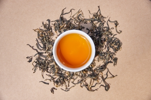 Tea leaves and drink on table - Australian Stock Image