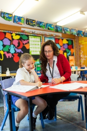 Teacher and Student Working Together in Classroom - Australian Stock Image