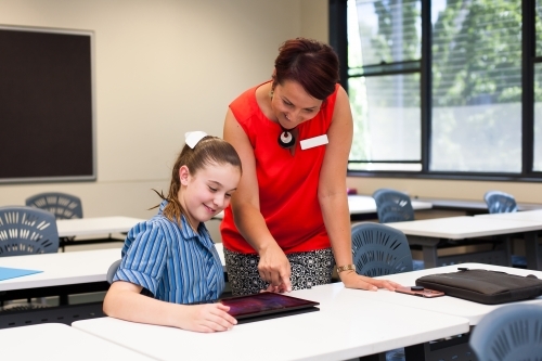 teacher helping a year 7 student in a classroom - Australian Stock Image