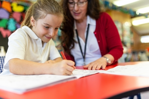 Teacher Helping Student Draw - Australian Stock Image