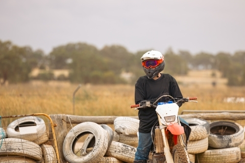 Teen boy riding motorbike at motocross track meet - Australian Stock Image